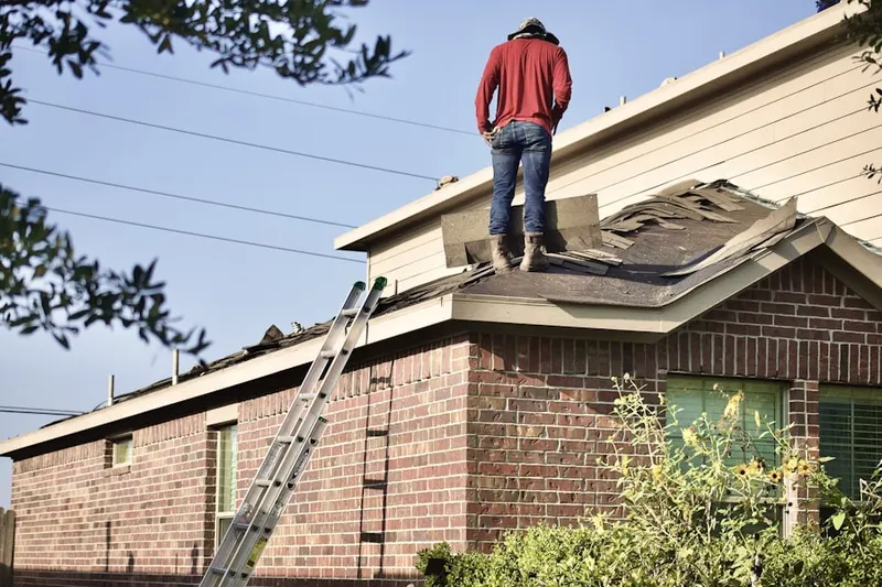 Professional roofer working on a residential roof in West Fairfield